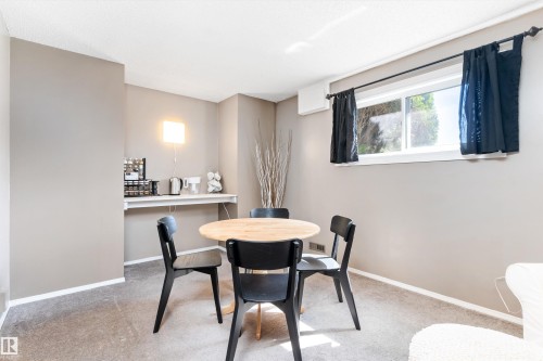 Inviting dining area featuring warm gray wall tones and plush carpet flooring - 15252 81 Street, Edmonton, AB 