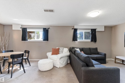 Carpeted recreation area with neutral wall tones and multiple windows - 15252 81 Street, Edmonton, AB 