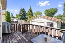 Exterior wooden deck with dark brown railing - 