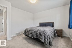 Spacious room featuring light gray carpet flooring and white walls - 