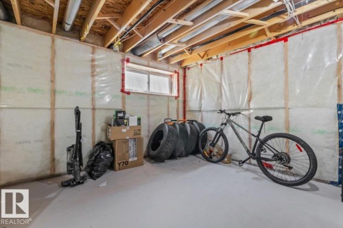 Unfinished basement space featuring exposed wood joists, insulated walls, and a concrete floor - 125 Birchwood Close, Devon, AB 