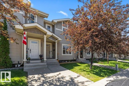 Exterior townhouse with horizontal siding and decorative shingle accents - 125 Birchwood Close, Devon, AB 
