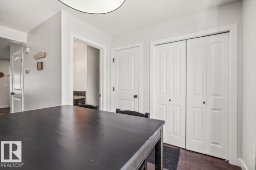 Expansive dark-finish tabletop with two white bi-fold closet doors, a white paneled door, and a white ceiling light fixture - 125 Birchwood Close, Devon, AB 