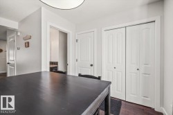 Expansive dark-finish tabletop with two white bi-fold closet doors, a white paneled door, and a white ceiling light fixture - 