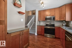 Kitchen featuring Stainless Steel Appliances, Ample Cabinets, Counter Space, and Storage with South Facing Window overlooking your Private Backyard. - 