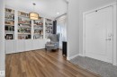 Custom built-in shelving with lower cabinetry and an overhead drum pendant light - 3256 Winspear Crescent, Edmonton, AB 