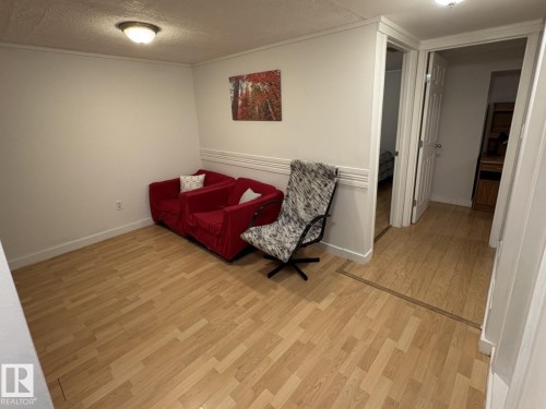 Light wood-finish flooring extending into adjacent rooms - 11511 101 Street, Edmonton, AB 