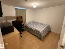 Light wood-finish flooring complements the neutral wall color - 