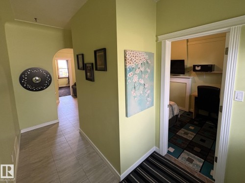 Inviting entryway with light green walls and tile flooring - 11511 101 Street, Edmonton, AB 