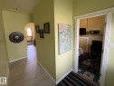 Inviting entryway with light green walls and tile flooring - 11511 101 Street, Edmonton, AB 