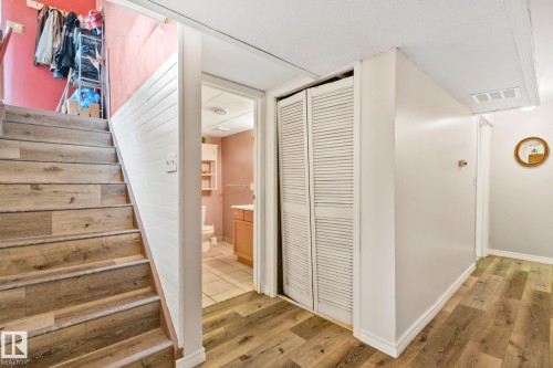 Wood-finish flooring throughout, with a paneled stairway wall - 30 Garden Valley Drive, Stony Plain, AB - Indoor Photo Showing Other Room