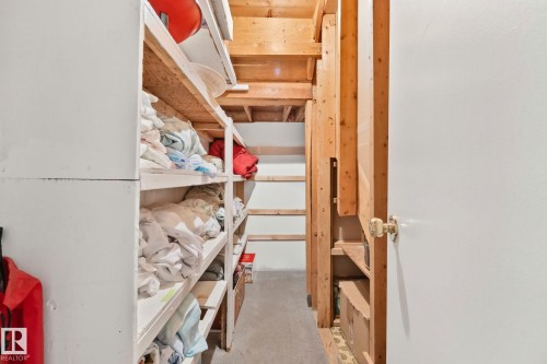 Unfinished basement area featuring exposed wood framing, concrete flooring, and built-in shelving - 30 Garden Valley Drive, Stony Plain, AB - Indoor