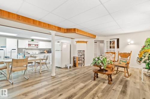 Open-concept lower level featuring wood-finish flooring, white cabinetry, recessed lighting, and a drop ceiling - 30 Garden Valley Drive, Stony Plain, AB - Indoor