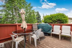 Spacious outdoor deck featuring natural wood flooring and a perimeter privacy fence - 