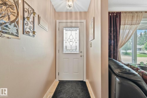 Entryway featuring a white door with decorative glass inserts, ceramic tile flooring, and a ceiling-mounted light fixture - 30 Garden Valley Drive, Stony Plain, AB - Indoor Photo Showing Other Room