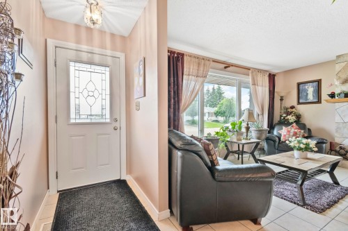 Foyer with a leaded glass entry door, overhead light fixture, and tile flooring - 30 Garden Valley Drive, Stony Plain, AB - Indoor Photo Showing Other Room