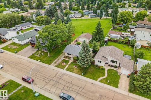 Aerial perspective showcasing a residential street with properties featuring mature landscaping and green lawns - 30 Garden Valley Drive, Stony Plain, AB - Outdoor With View