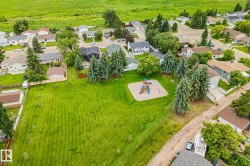 Aerial perspective showcasing a residential neighborhood with a central park space - 