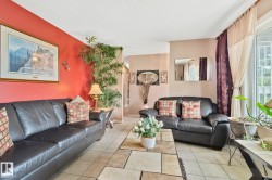 Living area featuring tile flooring, a large sliding glass door, and recessed lighting - 