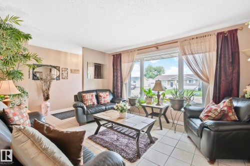 Bright living space featuring a large window, tiled flooring, and neutral wall tones - 30 Garden Valley Drive, Stony Plain, AB - Indoor Photo Showing Living Room