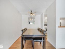 Dining area featuring wood-finish flooring and a ceiling fan - 
