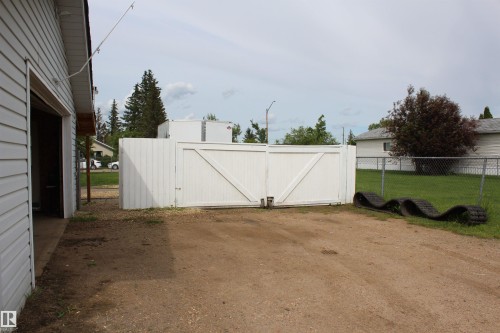 White privacy fence with double gates - 4839 49 Avenue, Chipman, AB 