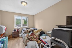 Room featuring light wood-finish flooring, a double-paned window, and a flush-mount ceiling light - 