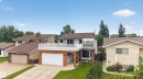 Split-level residence featuring a prominent upper-level deck with white railings - 3841 62 Street, Edmonton, AB 