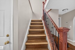Wood-finish staircase featuring light risers and darker treads - 