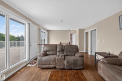 Spacious room featuring wood-finish flooring and neutral wall tones - 
