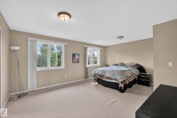 Spacious room featuring neutral carpeting and light tan wall paint - 