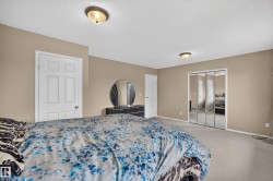 Carpeted room featuring a four-panel mirrored closet, neutral wall paint, and white trim doors - 