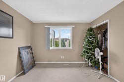 Room featuring neutral wall paint, white trim, and carpet flooring - 