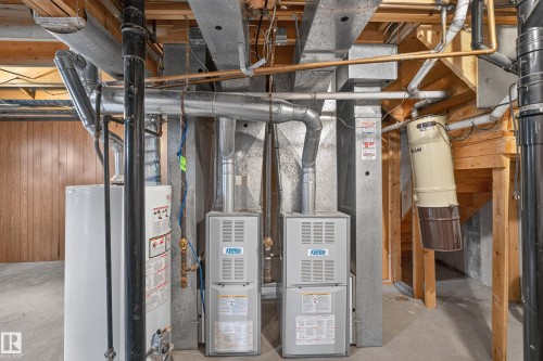 Dual-unit forced-air heating system with exposed ductwork, water heater, and central vacuum system - 3841 62 Street, Edmonton, AB 