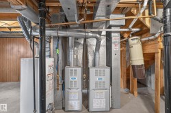 Dual-unit forced-air heating system with exposed ductwork, water heater, and central vacuum system - 
