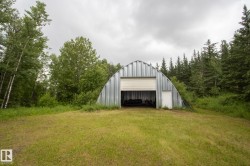 Quonset hut structure with a corrugated metal exterior - 