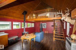 Vaulted wood-paneled ceilings with exposed beams complement the wood-finish flooring - 