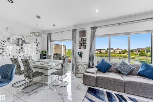Living and dining area featuring large format white marble-look tile flooring - 5809 65 Street, Beaumont, AB - Indoor