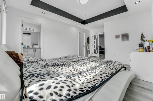 Recessed lighting, wood-finish flooring, and a tray ceiling with a dark accent - 5809 65 Street, Beaumont, AB - Indoor Photo Showing Bedroom