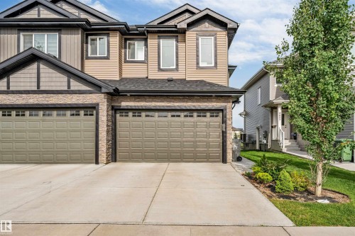 Contemporary exterior featuring stone veneer accents, horizontal siding, and dark trim details - 5809 65 Street, Beaumont, AB - Outdoor