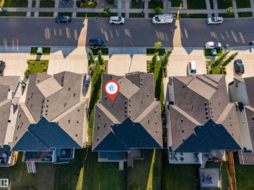 Aerial view showcasing a residential property with a multi-gabled roof and dark shingles - 5809 65 Street, Beaumont, AB - Outdoor With View