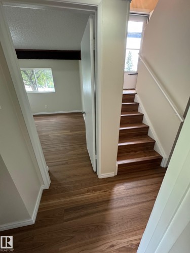 Wood-finish flooring throughout, complemented by white baseboards and trim - 482 Lee Ridge Road Nw, Edmonton, AB 