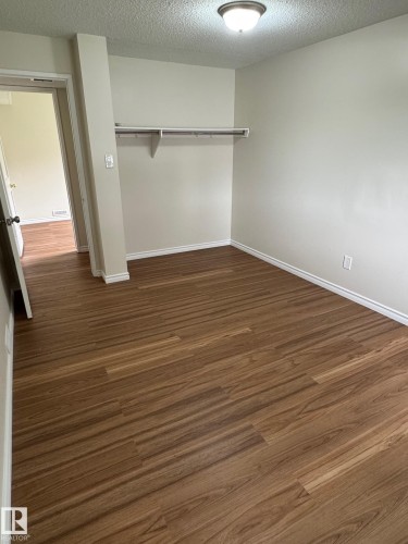 Room featuring wood-finish flooring, light neutral wall paint, and white baseboards - 482 Lee Ridge Road Nw, Edmonton, AB 