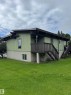 Split-level residence featuring light green vertical siding and a dark brown trim - 482 Lee Ridge Road Nw, Edmonton, AB 