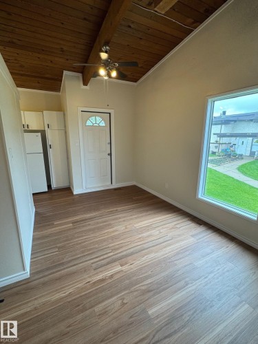Spacious room featuring wood-finish flooring and a vaulted wood plank ceiling with exposed beams - 482 Lee Ridge Road Nw, Edmonton, AB 