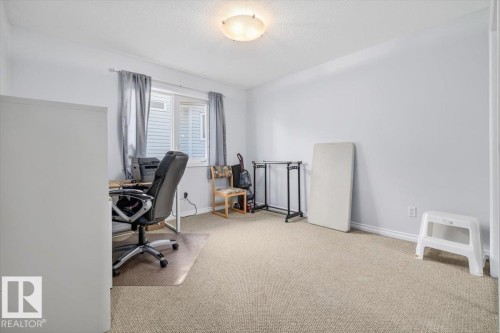 Carpeted room with light-toned walls and a flush-mount ceiling light fixture - 6050 164A Avenue, Edmonton, AB - Indoor