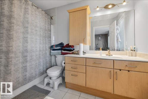 Bathroom featuring a light wood-finish vanity with a light-toned countertop - 6050 164A Avenue, Edmonton, AB - Indoor Photo Showing Bathroom
