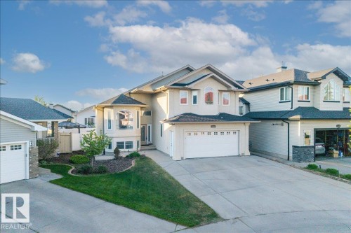 Contemporary stucco exterior featuring a bay window, a double garage, and a concrete driveway - 6050 164A Avenue, Edmonton, AB - Outdoor With Facade