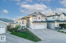 Contemporary stucco exterior featuring a bay window, a double garage, and a concrete driveway - 6050 164A Avenue, Edmonton, AB  - Outdoor With Facade 