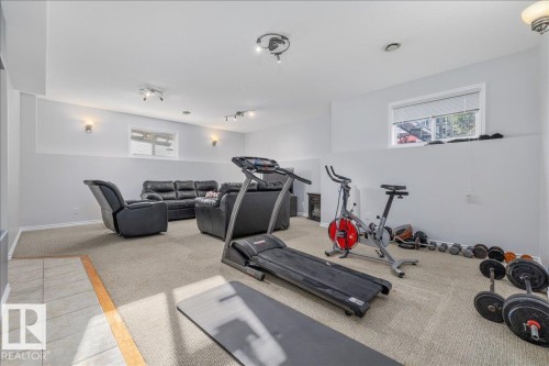 Finished lower level featuring recessed lighting, carpeting, a window, and wall sconces - 6050 164A Avenue, Edmonton, AB - Indoor Photo Showing Gym Room